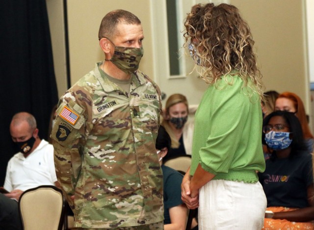 Sergeant Major of the Army Michael Grinston talks to a military spouse at a town hall meeting during his visit on Fort Bliss, Texas, May 11, 2021. The visit was an opportunity to listen to service members and their spouses to identify any issues in order to find a suitable solution. During the visit, Grinston engaged with students of the Noncommissioned Officer Leadership Center of Excellence; held a military spouse quality of life town hall; held a local media engagement to discuss quality of life initiatives to support Soldiers; conducted a garrison walk-through, and discussion with Soldiers. (U.S. Army photo by Staff Sgt. John Onuoha, 5th Armored Brigade)