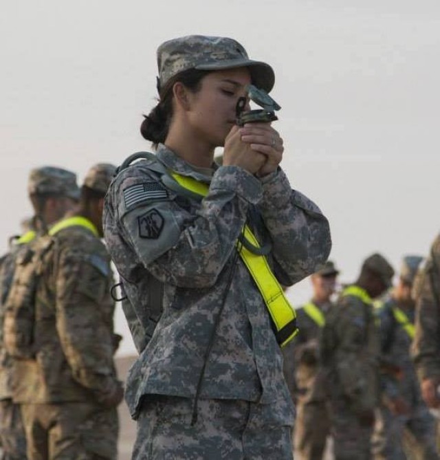 Spc. Christina Kring, human resources specialist, 510th Human Resources Company, Fort Eustis. Va., plots her coordinates during a land navigation course, Camp Arifjan, Kuwait, 2014. Kring, now a staff sergeant, currently serves as a recruiter with...