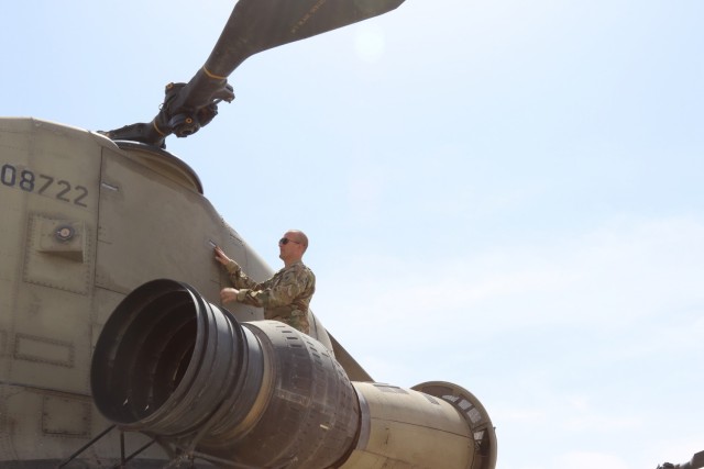 Staff Sgt. Brandon Stafford preps a Task Force Phoenix CH-47 Chinook helicopter for flight at Camp Buehring Kuwait. Stafford is a CH-47 Chinook helicopter flight engineer and flight instructor with the Minnesota and Iowa National Guard's B Company, 1st Battalion, 171st Aviation Regiment (General Support Aviation Battalion).