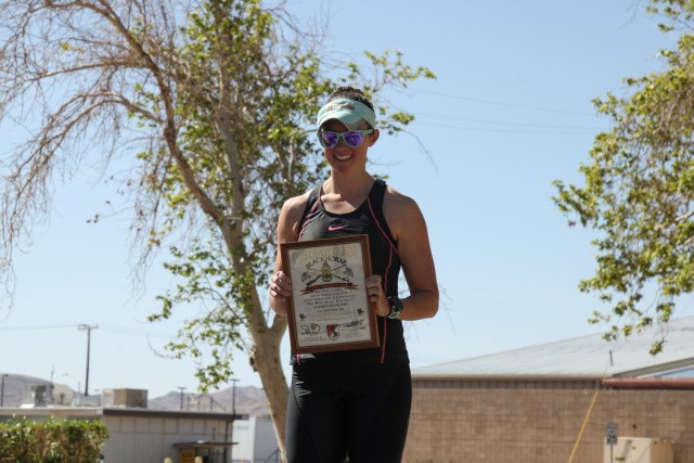Maj. Kathryn Buckland, the chief of the resource management division for Weed Army Community Hospital, poses for a photo April 3, 2021, after placing first in the female category in a triathlon on Fort Irwin, Calif. Buckland, a Leesburg, Va., native, trained for the triathlon while pursuing a fellowship with the American College for Healthcare Executives, which she earned in March 2021. (U.S. Army photo by Spc. Gower Liu/ 11th ACR Public Affairs)