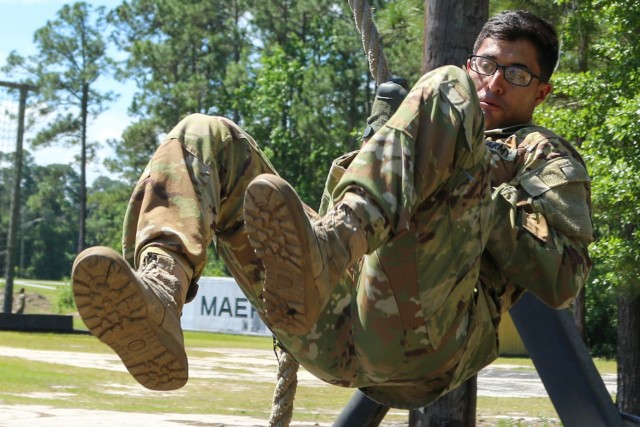 Sgt. Nikky Otero, a UH-60 helicopter repairer assigned to 4-3 Assault Helicopter Battalion, 3rd Combat Aviation Brigade, 3rd Infantry Division, swings on a rope as part of an obstacle course during the Division's Soldier and Noncommissioned Officer of the Year Competition at Fort Stewart, Georgia, May 6, 2021. The candidates ran through 17 different obstacles for the competition. (U.S. Army photo by Spc. Jose Escamilla)
