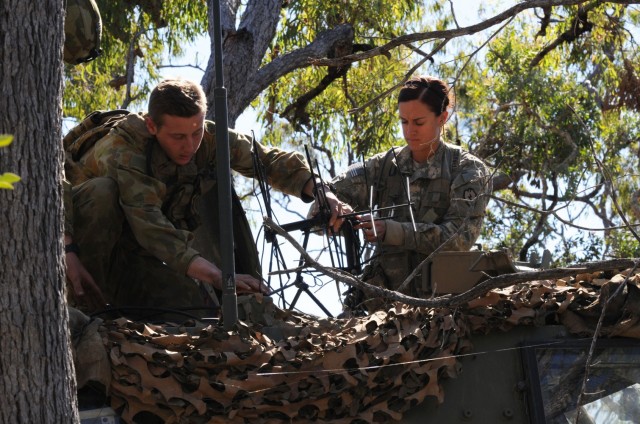 Pvt. Stefan Rstuccia (left), a signaleer with the 3rd Brigade Australian Army, and Sgt. Amanda Carrasco, a signal support systems specialist with 2nd Battalion, 27th Infantry Regiment, sets up an antenna during Talisman Sabre 15 at Shoalwater Bay Training Area, Australia. The C5ISR Center is a participant in the Engineering and Scientist Exchange Program, which allows DoD civilian scientists and engineers the opportunity for a rotation with allied nations such as Australia. (U.S. Army photo by Sgt. Sinthia Rosario, 5th Mobile Public Affairs Detachment)