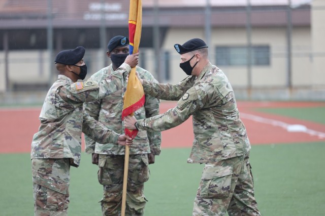 Brig. Gen. Steven Allen, commander, 19th Expeditionary Sustainment Command, passes the command colors to Sgt. Maj. Larry Cuffie, NCOIC of ceremony, during a relinquishment of responsibility ceremony for Command Sgt. Maj. LaDerek Green, center, on...