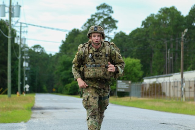 Sgt. Hunter Davidson, an infantryman assigned to 3rd Battalion, 15th Infantry Regiment, 2nd Armored Brigade Combat Team, 3rd Infantry Division, sprints to finish the 12-mile foot march during the 3rd Infantry Division Soldier and Noncommissioned Officer of the Year Competition at Fort Stewart, Georgia, May 5, 2021. Davidson finished the foot march with a time of three hours and five minutes. (U.S. Army Photo by Spc. Jose Escamilla)
