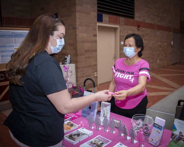 Reyne Husky provides women’s health information during a Breast Cancer Awareness event at Brooke Army Medical Center, Fort Sam Houston, Texas, May 7, 2021. Husky was able to discover her own breast cancer after attending a similar event. (U.S. Army photo by Jason W. Edwards)