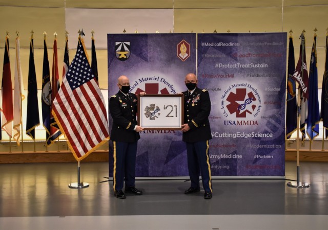 MAJ Dana Love presented with USAMMDA group photo