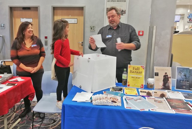 
William Montgomery (right) announces one of the winners during the Customer Appreciation Day event at the Wiesbaden Entertainment Center.