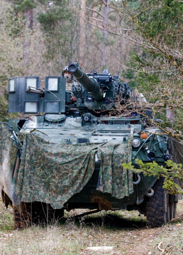 A 2nd Cavalry Regiment Soldier pulls security in the woodline from a Stryker vehicle during the Dragoon Ready 21 training exercise at Hohenfels Training Area, Germany, April 17, 2021. Dragoon Ready 21 is a 7th Army Training Command-led exercise...