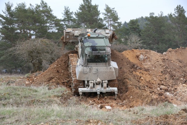 An armored bulldozer assigned to the 2nd Cavalry Regiment drags dirt during Dragoon Ready 21 at the Hohenfels Training Area, April 17, 2021. Daily training, conducted in realistic environments, under realistic circumstances, ensures our forces maintain the highest levels of proficiency and readiness for worldwide deployment. (U.S. Army photo by Sgt. Julian Padua)