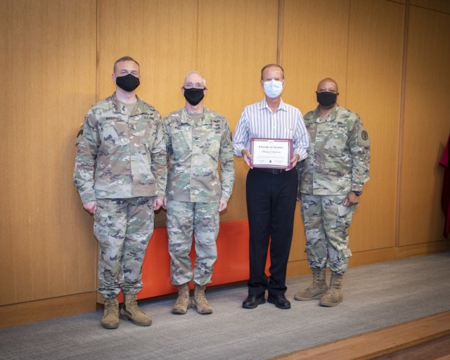 Brig. Gen. Shan K. Bagby, U.S. Army Regional Health Command – Central commanding general, Col. Michael Wirt, Brooke Army Medical Center commander, and Sgt. Major Gabriel Wright, chief clinical noncommissioned officer, present Michael Dulevitz,...