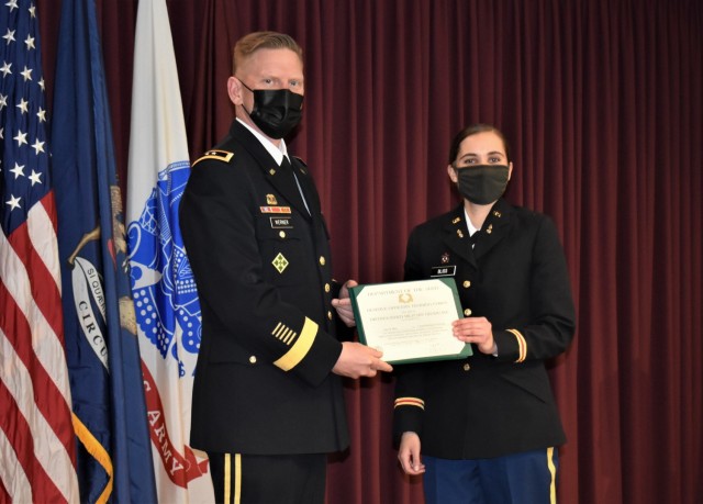 Maj. Gen. Darren Werner, commander of the Tank-automotive and Armaments Command, presents a Distinguished Military Graduate award to 2nd Lt. Anja Bliss during a Pinning and First Salute ceremony held at Central Michigan University May 9. Werner...