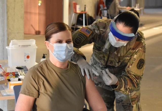 MONS, Belgium – Col. Kathy Spangler, left, commander of the SHAPE Healthcare Facility and Brussels Army Health Clinic, receives a COVID-19 vaccination Jan. 8 at the SHAPE clinic at Mons, Belgium. The SHAPE Healthcare Facility and Brussels Army Health Clinic conducted their first inoculations of healthcare workers with the Moderna COVID-19 vaccine Jan. 7. (U.S. Army photo by Christophe Morel, U.S. Army Garrison Benelux Public Affairs Office)