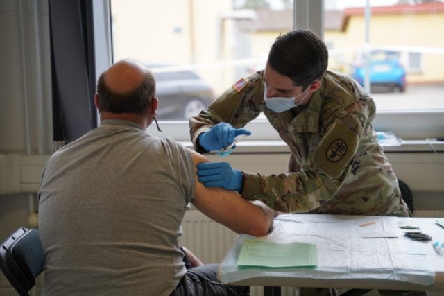 A local national receives the COVID-19 vaccine from the U.S. Army