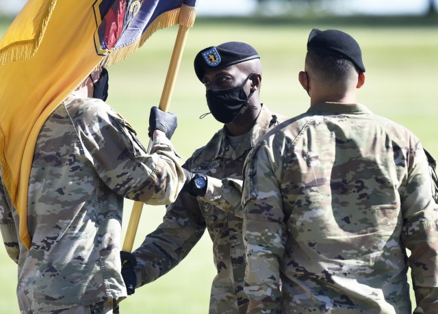 Incoming 3rd Chemical Brigade Command Sgt. Maj. Joe Johnson (center) accepts the brigade colors from Col. Adam Hilburgh (left), brigade commander, as outgoing Command Sgt. Maj. Jorge Arzabala looks on, during a change-of-responsibility ceremony...