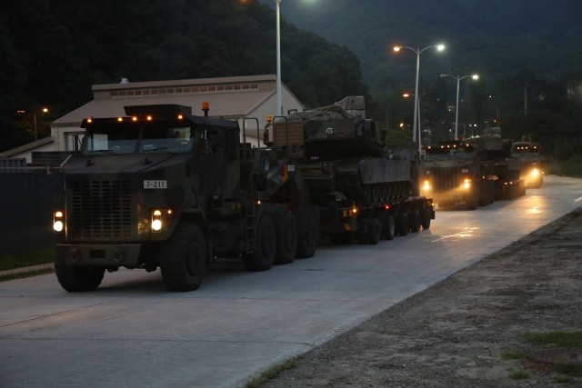 HET tractor and trailer movement with HET convoy operations during nighttime.