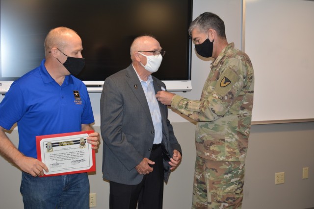David Fulmer, Fort Riley Deputy to the garrison commander, left and Col. William McKannay, Fort Riley garrison commander, right present Rick Hearron, garrison safety directory, center with awards during his retirement ceremony April 30.