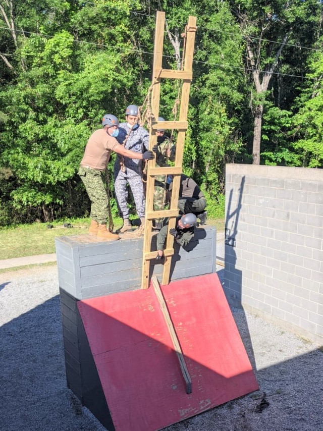 Students currently enrolled in the Transnational Threats Network Intelligence Analysis (T2NIA) course tackle one of the stations at the Fort Benning Leader&#39;s Reaction Course.