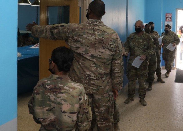 Soldiers deployed to Camp Arifjan, Kuwait, line up May 5, 2021 to receive the COVID-19 vaccine upon the restart of vaccine administration after a month-long halt on vaccinations in the U.S. Central Command area of responsibility. The &#34;Desert...