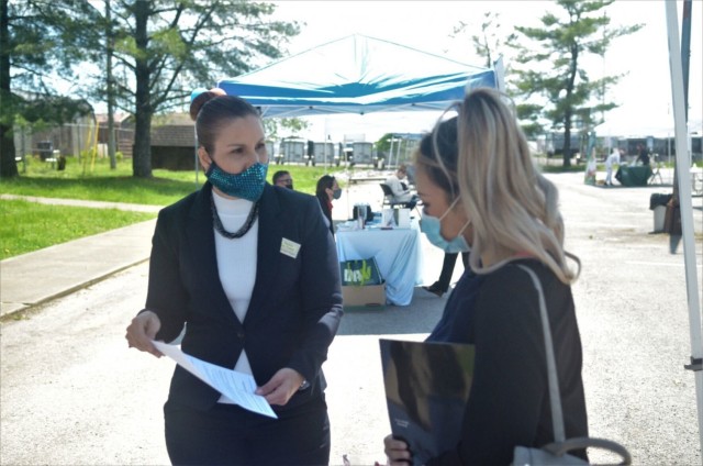 Migdalia Rosado Diaz, left, human resources specialist, Civilian Personnel Advisory Center, speaks with Sapphire Thal, Army spouse, May 6 during the Open Air Hiring Fair at the Spouse Employment Center. More than 100 people interacted with 23...