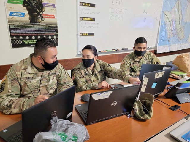 Hawaii Army National Guard Maj. Allen Tudela, Chief Warrant Officer 2 Francess Ann G. Cho, and Sgt. Nikolai B. Sumibcay of 103d Troop Command, collaborate during Exercise Tiger Balm 2021 at the 298th Regiment, Regional Training Institute (RTI), Waimanalo, Hawaii, May 7, 2021. Exercise Tiger Balm is the longest-running bilateral exercise the Singapore Armed Forces has with any defense force partner since 1981. (U.S. Army National Guard photo by Sgt. Matthew A. Foster)