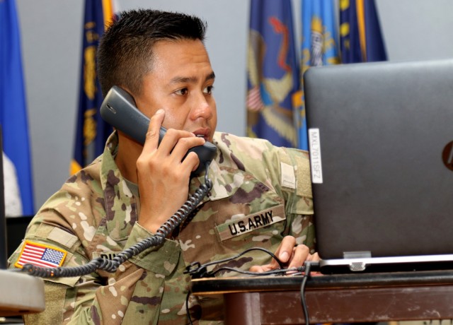 Hawaii Army National Guard Capt. Randall S. Duldulao, assigned to the 29th Infantry Brigade Combat Team, receives information about a simulated incident during Exercise Tiger Balm 2021 at the 298th Regiment, Regional Training Institute (RTI), Waimanalo, Hawaii, May 10, 2021. Exercise Tiger Balm is a bilateral exercise with the Singapore Armed Forces to build combat readiness and strengthen interoperability between the United States and Singapore Armed Forces. (U.S. Army National Guard photo by Sgt. Matthew A. Foster)