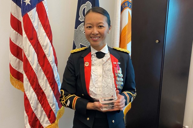 Army Col. Danielle Ngo, the executive officer to the Army Inspector General, displays her Asian-American Engineer of the Year trophy in her office at the Pentagon, May 4, 2021.