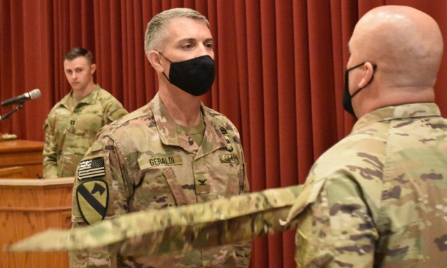 Colonel Mark Geraldi and Sergeant Major Ronald Brown, take a moment to pause and honor the accomplishments of the Afghanistan District as the colors are cased for the final time on May 15, 2021.