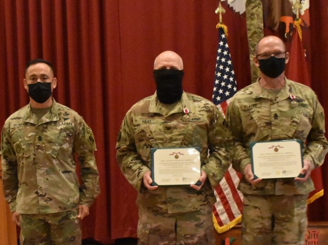 Colonel John Haas Jr., Task Force Essayons Commander, and Sergeant Major William Klaers, Senior Enlisted Advisor, Task Force Essayons, display their Meritorious Service Medals presented to them by Command Sergeant Major Delfin Romani,...