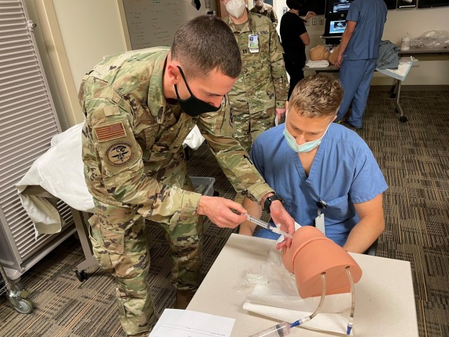 Brooke Army Medical Center's Simulation Center Chief Maj. John Hunninghake teaches arthrocentesis to Martin Army Community Hospital's residents and staff during the FCCS/ICTL Course.