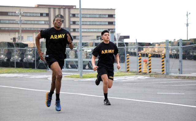 Sgt. Jamal Walker, left, assigned to the U.S. Army Japan Band, and Spc. Izak Ramirez, assigned to the 38th Air Defense Artillery Brigade, compete in the run portion of the Army Combat Fitness Test during the 2021 U.S. Army Japan Best Warrior Competition at Camp Zama, Japan, May 12.
