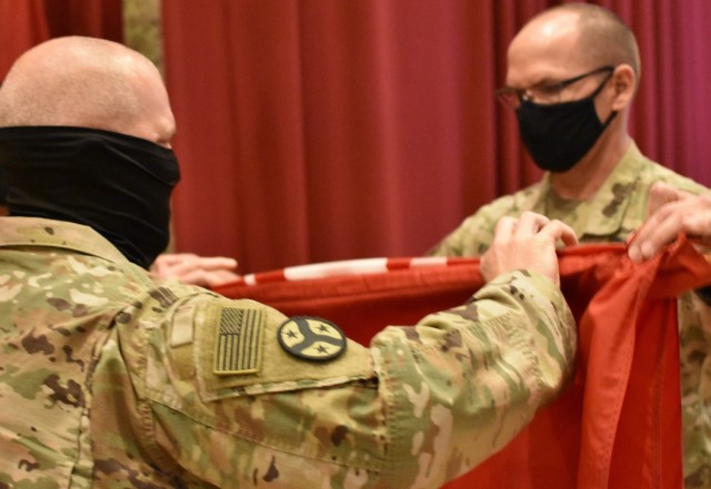 Colonel John Haas, Jr. Task Force Essayons Commander and Sergeant Major William Klaers prepare the Task Force Essayons Colors to be cased as the unit ends a legacy of service on May 15, 2021. (Photo by Rick Benoit)