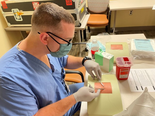 Martin Army Community Hospital's 3rd-year resident Capt. Douglas May practices suturing during Brooke Army Medical Center's FCCS/ICTL Course.