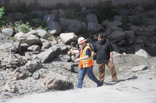 Reach 2a project manager Trevor Snyder, black shirt, and biologist Jon Rishi check for nesting birds as they transit an overpass above the Los Angeles River, May 4, 2021.