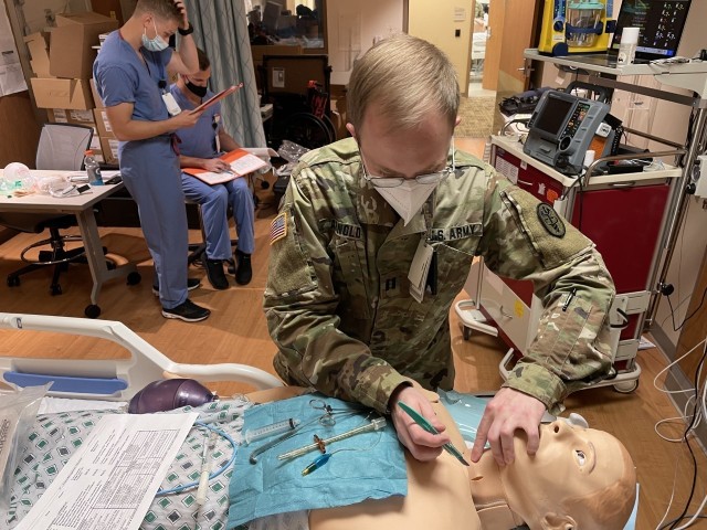 Martin Army Community Hospital's ER Physician Capt. Jacob Arnold performed a cricothyroidotomy on a patient, under the tutelage of BAMC Pulmonary and Critical Care Medicine Chief Lt. Col. Robert Walter.