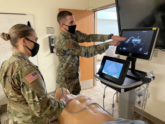 Brooke Army Medical Center Simulation Center Chief Maj. John Hunninghake shows Martin Army Community Hospital's 3rd-year resident Maj. Shelley Flores how to read an eFAST (extended focused assessment with sonography for trauma).