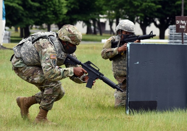 Staff Sgt. Hatali Broderick, left, assigned to the 78th Signal Battalion, and Spc. Brooke Hendricks, assigned to the U.S. Army Japan Band, compete in the react-to-contact lane during the 2021 U.S. Army Japan Best Warrior Competition at Sagami General Depot, Japan, May 12. 