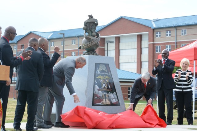 Members of the Ordnance Corps Association unveil a memorial dedicated to fallen Soldiers May 14, 2021, at Whittington Field on Fort Lee. The statue was also created to honor the centennial of the Army Ordnance Corps, which occurred May 14, 2012.