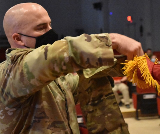Master Sergeant Ronald Brown wraps the colors of the Afghanistan District into the sleeve it will be encased in following the casing of the colors ceremony on May 15, 2021.