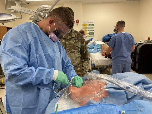 Martin Army Community Hospital's 3rd-year resident Capt. Ryan Coffey inserts a central line, under the tutelage of Brooke Army Medical Center's Pulmonary and Critical Care Medicine Physician Maj. Ian McInnis.