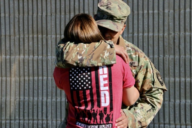 Staff Sgt. Luis Gonzalez, military police with the 50th Regional Support Group, says goodbye to his girlfriend prior to his deployment at the Homestead armory in Homestead, Florida. 