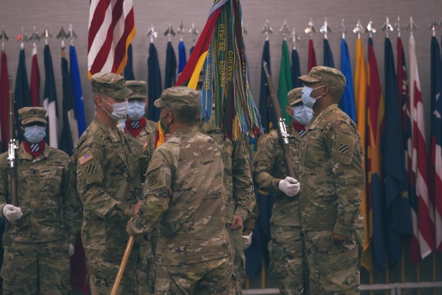 Maj. Gen. Antonio Aguto, commanding general of the 3rd Infantry Division, transfers the 3rd ID Artillery colors to incoming commander Col. William (Lee) Davis, during the DIVARTY change of command ceremony May 13, 2021, at Fort Stewart’s Club...