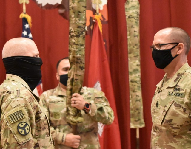 Colonel John Haas, Jr., Task Force Essayons Commander and Sergeant Major William Klaers, Task Force Essayons Senior Enlisted Advisor, watch as the command colors are cased and hoisted into place by Sergeant First Class Joseph Harrison on May 15,...