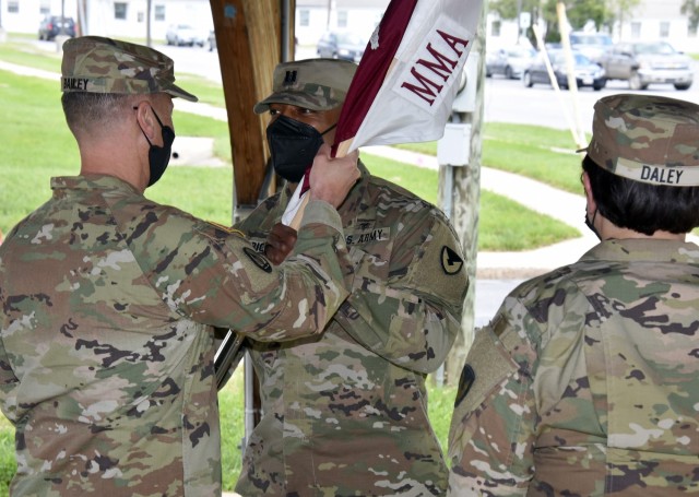Capt. Chris Wright, center, accepts the colors from Col. John “Ryan” Bailey as he becomes the new commander of the U.S. Army Medical Materiel Agency Detachment during a change of command ceremony May 13 at Fort Detrick, Maryland. Looking on is outgoing commander, Maj. Ivette Daley.