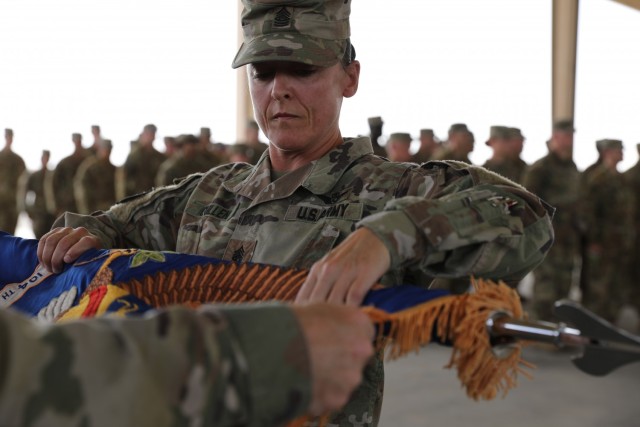 The 2-104th General Support Aviation Battalion's colors are cased during a transfer of authority ceremony. During the ceremony, the 2-104th GSAB formally transferred authority of their mission to the 1-168th GSAB. (U.S. Army photo by Sgt. 1st...