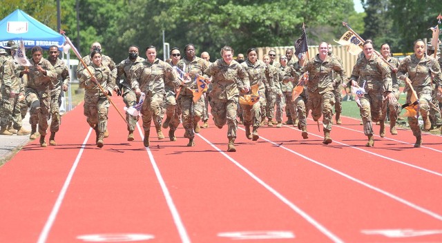 Dragon Brigade guidon-bearing Soldiers sprint toward the finish line during the Soldier Stakes Competition May 14 at Williams Stadium.