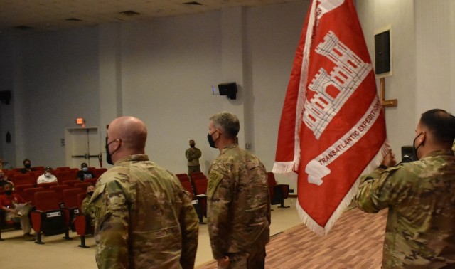 As Master Sergeant Ronald Brown, Senior Enlisted Advisor, and Colonel Mark Geraldi, Commander Pivot around to those attending the uncasing ceremony, they present the flag of the Transatlantic Expeditionary District on this date, May 15, 2021 from...