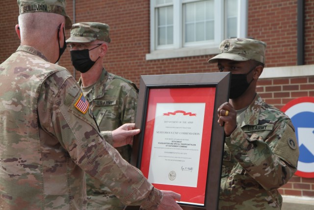 Staff Sgt. Nahjier Williams, public affairs noncommissioned officer, 1st Theater Sustainment Command,  represents the 1st TSC noncommissioned officers as the unit is awarded the Meritorious Unit Commendation by Maj. Gen. John Sullivan, commanding...