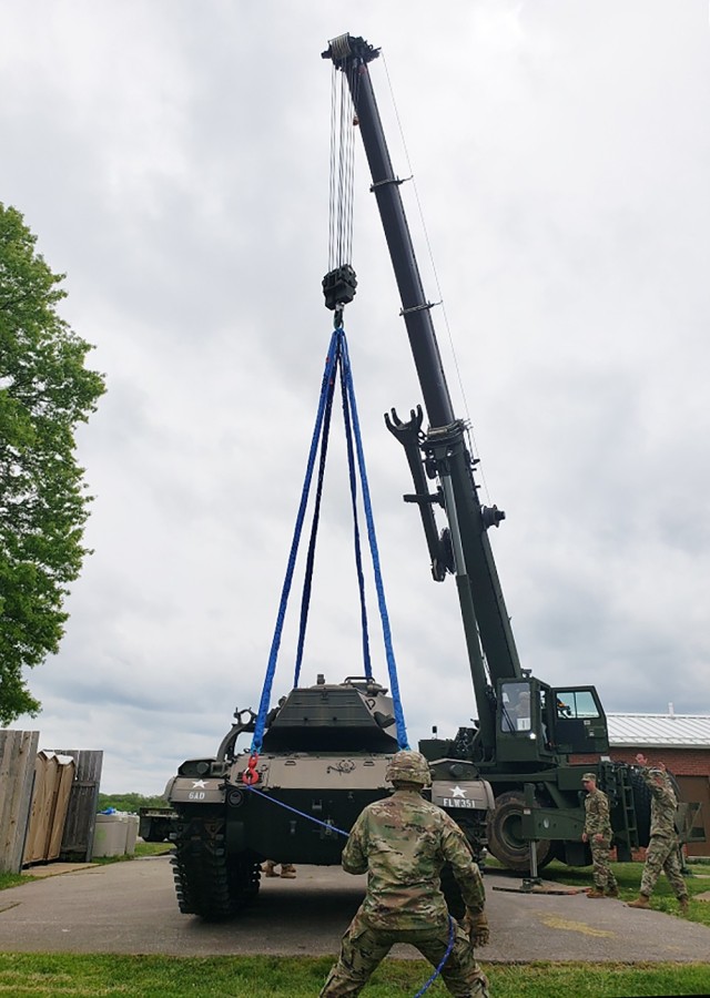 Horizontal construction engineer and bridge crewmember Soldiers with the 5th Engineer Battalion use one of their cranes to move a 23-ton M41 Walker Bulldog light tank May 11. The tank was on static display at the southeast corner of Iowa and...
