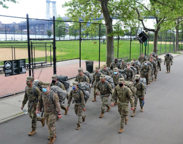 With the Williamsburg Bridge in the background, New York Army National Guard medics assigned to the Headquarters Company of the 1st Battalion, 69th Infantry Regiment hit the halfway point on a  six mile ruck march through Manhattan during the...
