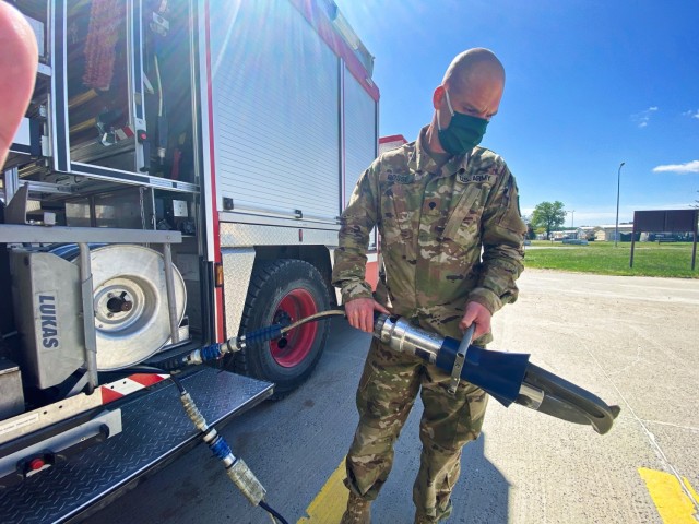 Specialist Trevor Bosse, a firefighter assigned to Mihail Kogalniceanu Air Base, Romania, operates a ‘Jaws of Life’ extraction tool May 18. Bosse, deployed from the Kentucky Army National Guard, is one of about 60 people composing the Directorate of Emergency Services here and Bulgaria protecting hundreds of U.S. and partner military members during exercise DEFENDER-Europe 21. (Photo by Jason Tudor)
